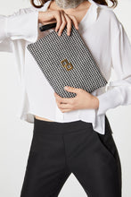 Load image into Gallery viewer, HAND-HELD CLUTCH IN A HOUNDS-TOOTH PRINT WITH GOLDEN LOGO
